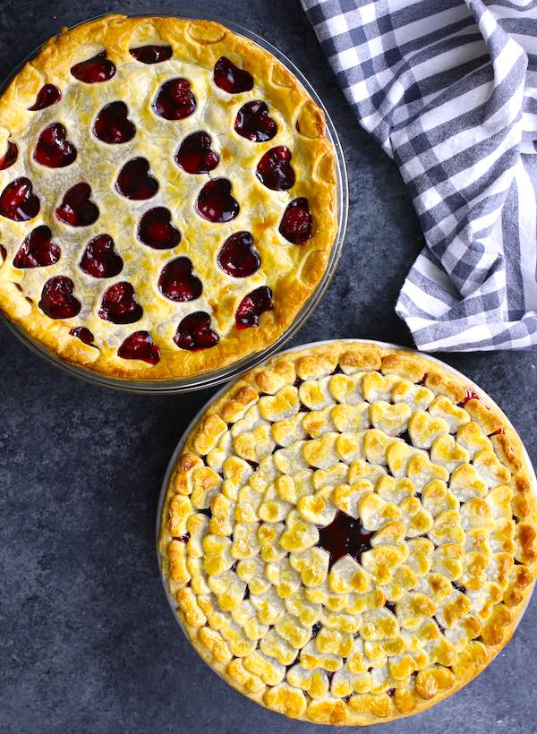 Overhead view of homemade cherry pie with heart shaped pastry patterns