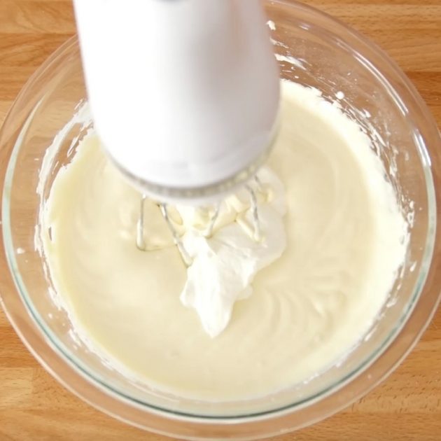 Mini Oreo Cheesecake Cupcakes - this photo shows making the cheesecake filling for this recipe in a mixing bowl with a hand mixer