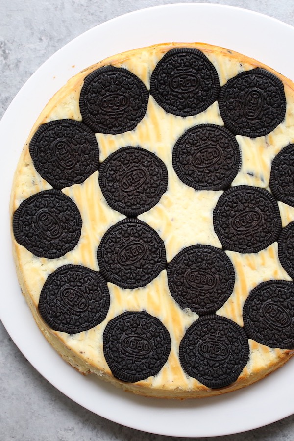 Upside Down Oreo Cheesecake is a simple 6 ingredient dessert made with cream cheese, eggs, yogurt, vanilla and whole oreo cookies on the bottom for a stunning presentation that's perfect for a party